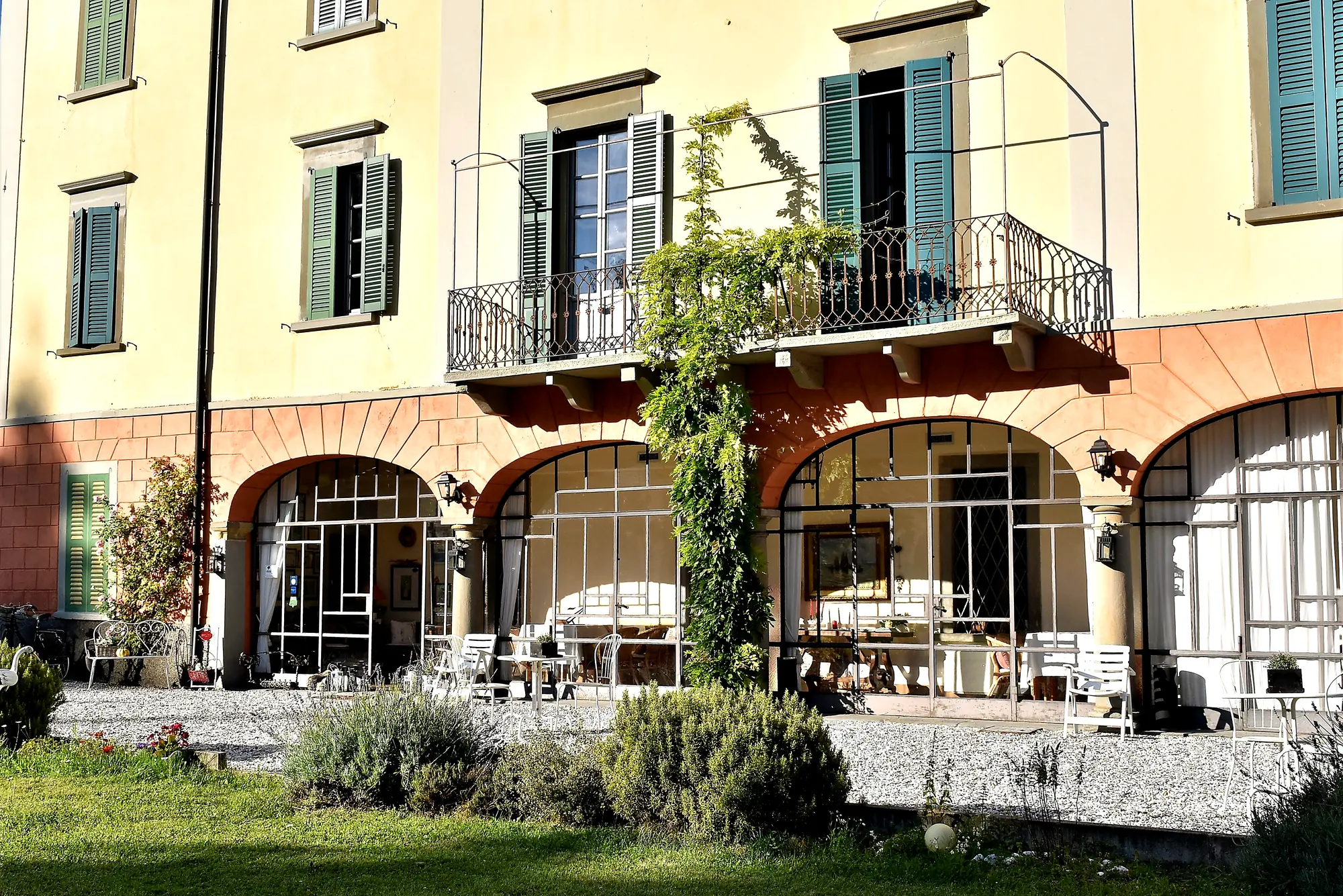 The arched veranda with the wisteria and flowers